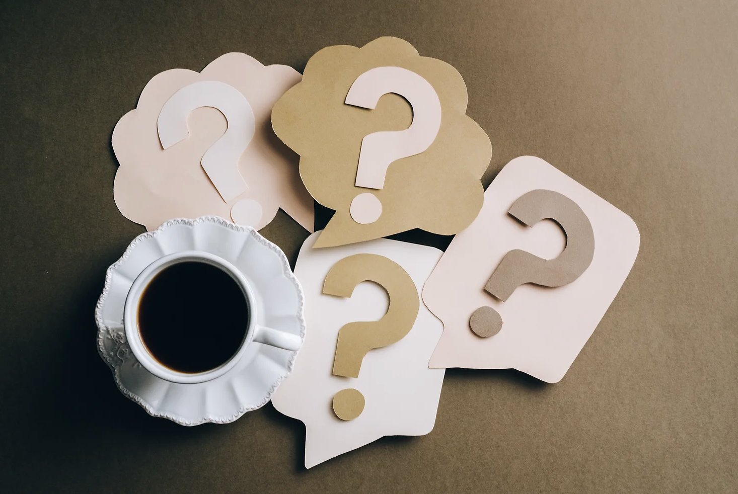 Question marks with cup of coffee